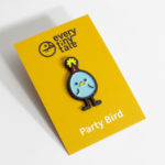 A photo of a Party Bird soft enamel pin, carded.