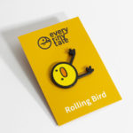 A photo of a Rolling Bird soft enamel pin, carded.