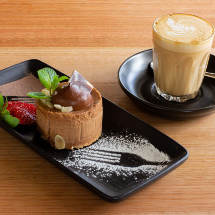 A photo of a chocolate mousse and a caffè latte.
